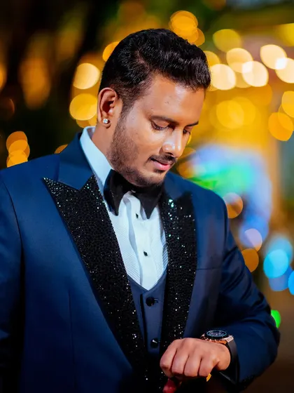 A classic portrait of the groom at the reception, with beautiful bokeh from the evening lights.