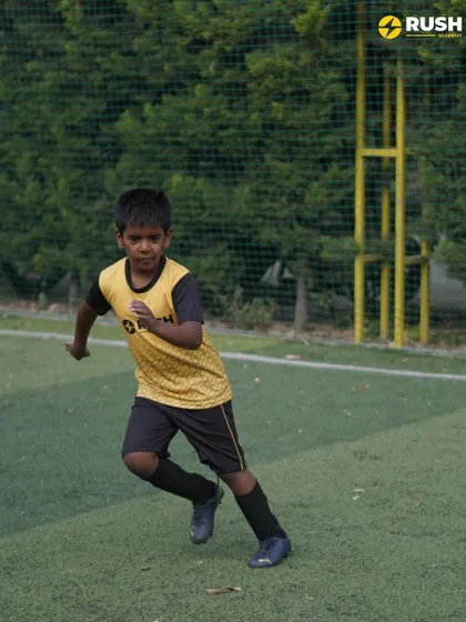 A young player sprints during a drill, showing the energy and enthusiasm that defines our academy.