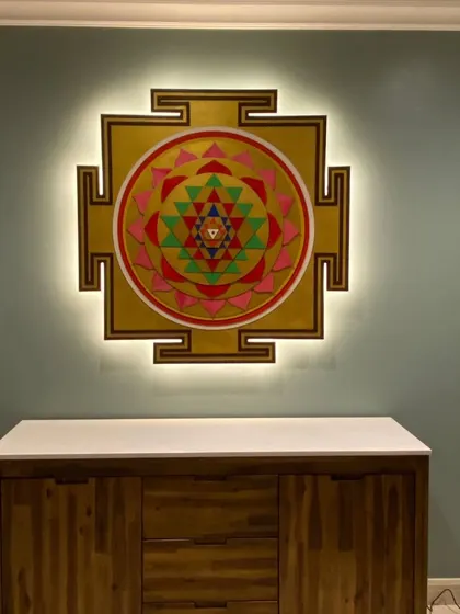 The same Shree Yantra with soft backlighting turned on, creating a gentle glow that accentuates the intricate layers of the piece.