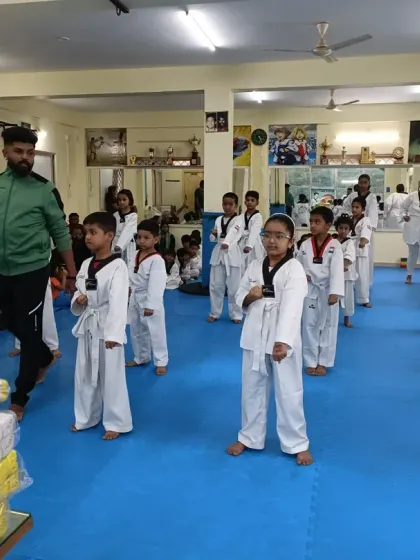 I stand with a class of white belts, ready to begin their training.