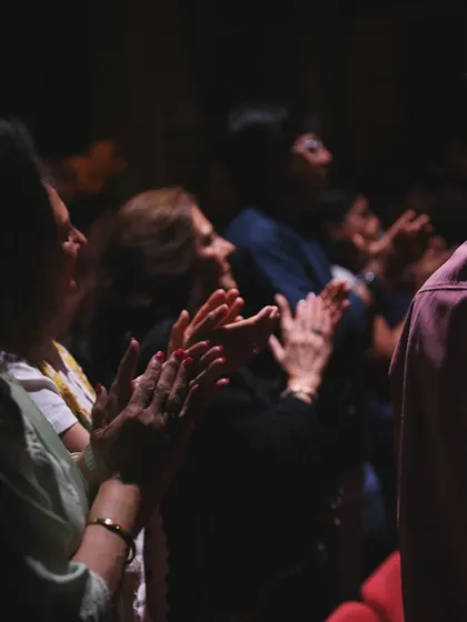 The audience in London, fully engaged and applauding during the show.