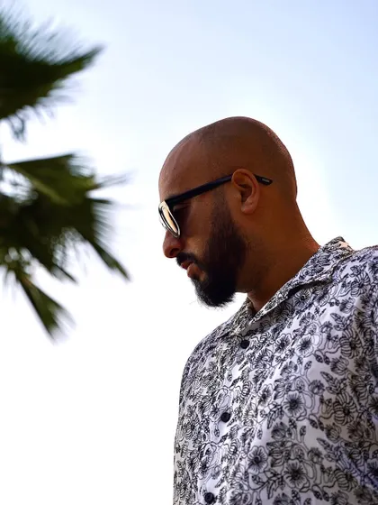 A profile shot against the clear sky. My focus is always forward, on the next beat, the next event, the next destination.