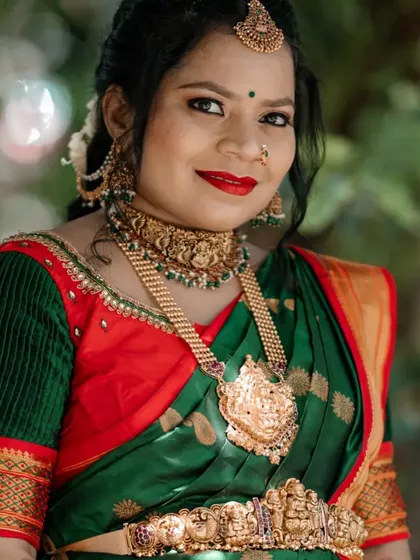 A close-up of the radiant mom-to-be. The intricate details of the Lakshmi choker and haram are clearly visible, showcasing the quality of my rental collection.