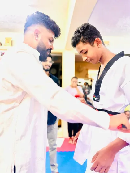 Tying the belt for a senior student.