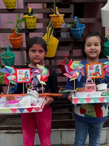 Two students with their matching Holi platters, ready to celebrate the festival together.