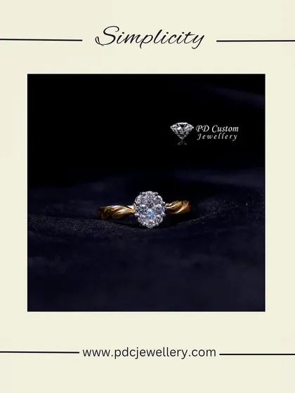 Simplicity and sparkle combined in this 18kt hallmarked gold and diamond ring. The twisted band enhances the brilliance of the oval-shaped diamond cluster.