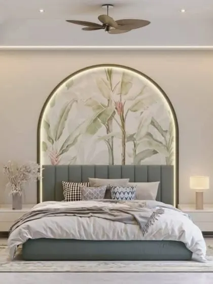 A soft, botanical mural within a backlit arch creates a tranquil and romantic atmosphere. This design serves as a perfect, calming headboard feature.