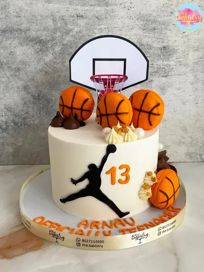 Officially a teenager! This basketball cake for Arnav's 13th birthday is a slam dunk, featuring the iconic Jordan silhouette, a hoop, and lots of basketballs.