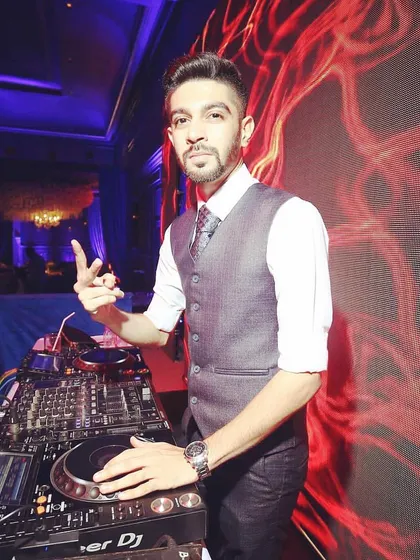 A simple, confident pose behind the decks. I'm ready to take control of the music and give your guests a night to remember.