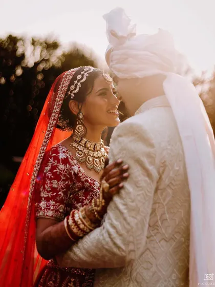 A golden hour portrait of a couple sharing an intimate moment, their faces close together, illuminated by the warm, soft light.