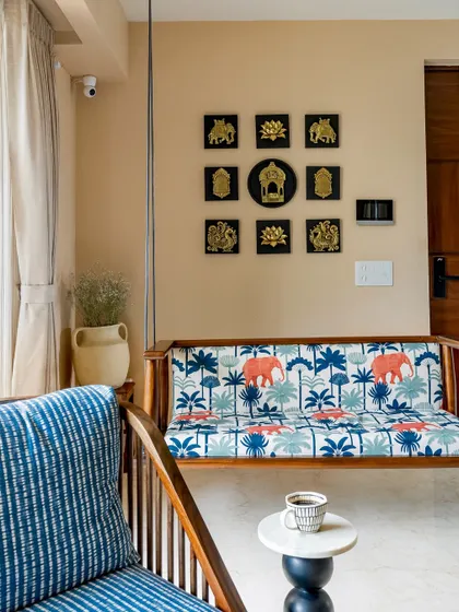 A close-up of the custom-made wooden swing (jhoola) in 'Project Lily,' featuring a vibrant elephant-print fabric. This piece adds a touch of traditional charm and playful elegance to the modern living space.