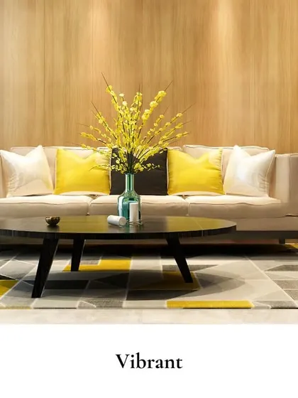 This vibrant living area is designed to feel warm and uplifting, with a wooden accent wall providing a natural backdrop for the bright yellow cushions and contemporary furniture.