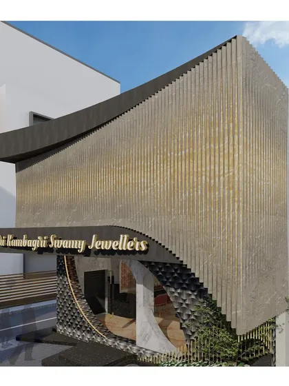 This angled view highlights the three-dimensional quality of the facade design. The way the curved entrance tucks under the main structure creates depth, while the textured materials provide tactile and visual interest from every approach.