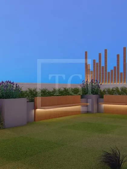 The lawn area of the Gurgaon project, featuring long, built-in benches with integrated lighting, perfect for large gatherings.