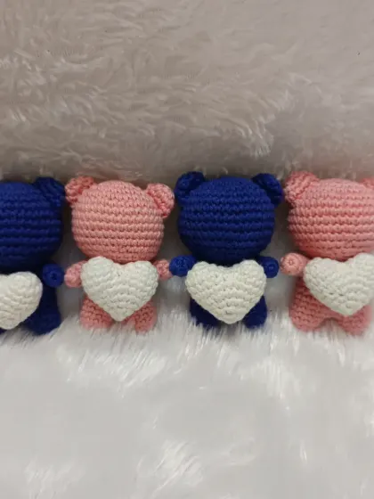 A set of four couple bear dolls, two in pink and two in blue, each holding a white heart. These make such a thoughtful gift for friends or loved ones.