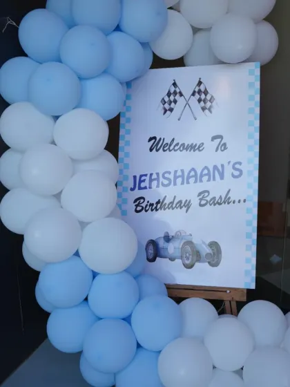 A classic race car theme for Jehshaan's birthday bash. The checkered flag motif and vintage car graphic create a cool, retro racing vibe.