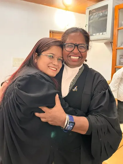 Sharing a hug and a beautiful smile with a colleague.