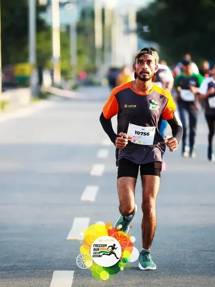 A runner shows focus and determination on the open road during the Freedom Run marathon.