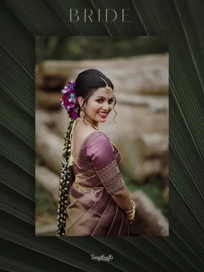 A beautifully framed portrait of the bride, her smile and traditional attire highlighted against a dark, natural background.