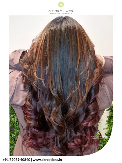 A full view from the back, showcasing the length and rich color of this gorgeous red balayage, styled in soft curls.