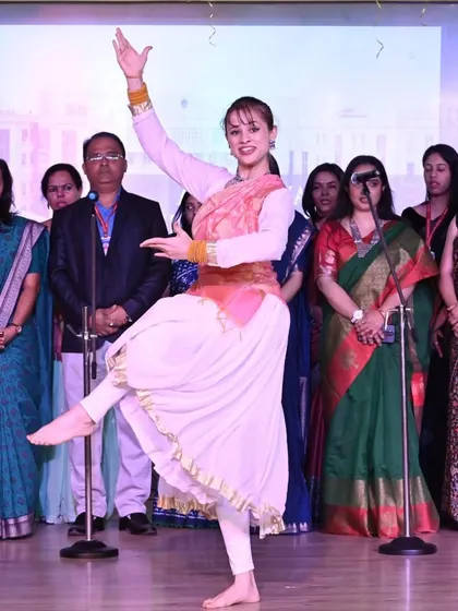 A graceful pose during a semi-classical stage performance. This highlights the importance of posture and clean lines in Indian dance, elements I focus on in my choreography.