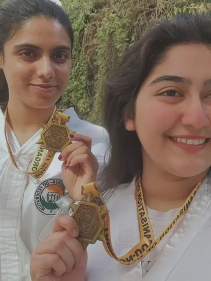 A close-up of two of our female champions and their hard-earned gold medals.