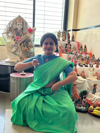 On the second day of Navratri, I pay obeisance to Brahmacharini. The pose here, in front of our family's Golu display, depicts her holding a Japamala and Kamandal, blending dance with home festivities.