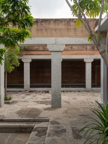 A view across the courtyard at the H.N. Science Center, where trees are planted within the paved area to provide shade and soften the stone architecture.