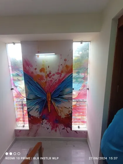 A vibrant butterfly mural installed in a staircase nook. This is a great way to add a splash of color and art to transitional spaces in a home.