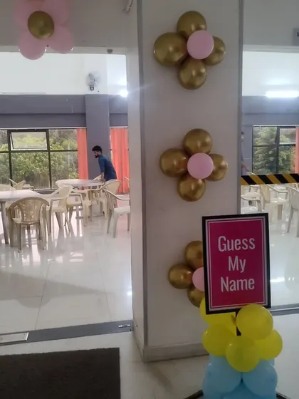 A simple decoration for a naming ceremony or baby shower. The small balloon clusters and custom sign are perfect for adding a personal touch to more intimate family events.