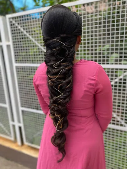An advanced, multi-layered braid with highlights, woven with a thin silver thread. This technique adds dimension and a touch of modern flair to a complex braid.
