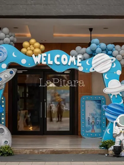 A closer look at the main entrance arch, showcasing the detailed cutouts of rockets, planets, and a moon rock.