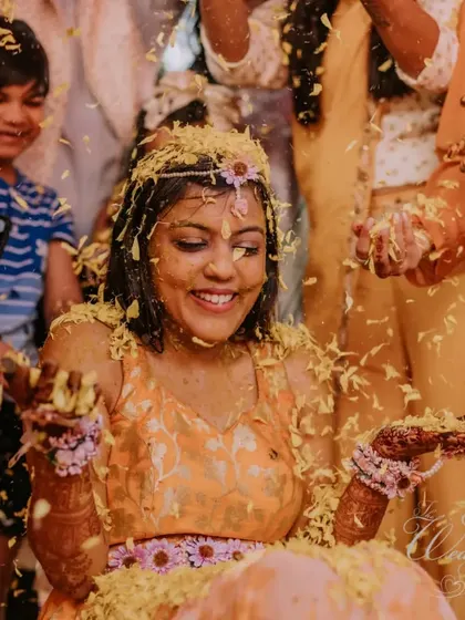 The bride's joyful expression as she's showered with flowers by her loved ones.