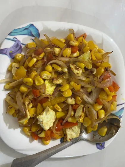 A colorful bowl of corn and paneer salad. A simple, no-cook meal that is perfect for a quick lunch or snack.