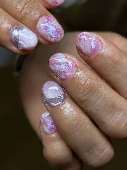 A delicate and artistic design featuring a marbled pink base with subtle silver accents. The texture and soft colors create a look reminiscent of rose quartz.
