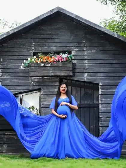The full, dramatic effect of our blue flying dress. The long trails extend out like wings, making for a powerful maternity portrait.