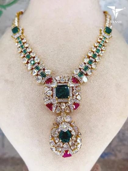 This piece is heavy, but only in craftsmanship. This is what happens when uncut diamonds meet heirloom scale emeralds and rubies. It is a one look piece, a one heirloom promise.