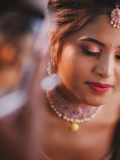 A soft and dreamy close up of a bride's makeup. The focus is on the delicate pink eyeshadow and the flawless skin.