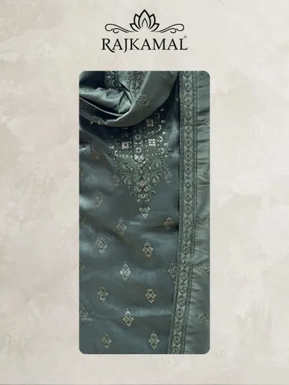 A detailed look at the fabric of the hunter green jacquard kurta, showing the subtle self-design and the embroidered neckline.