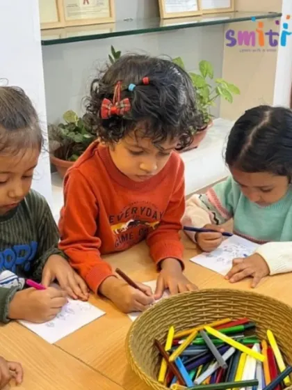 Three children sit side-by-side, engrossed in their coloring. Celebrating festivals together helps build cultural awareness and respect for diversity from a young age.