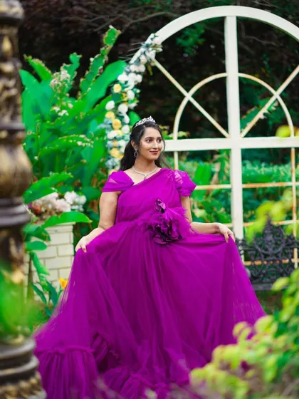 A client looking like a princess in our purple gown with a floral detail. This is a great rental option for baby showers or maternity shoots.