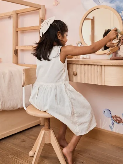 A close-up of my daughter at her dresser. This child-sized furniture from Inlila World is designed to support her growing autonomy.