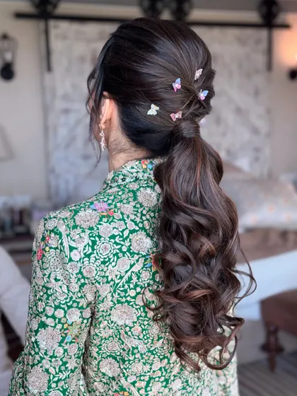 A whimsical and delicate ponytail for a fun event. I created a simple, wavy ponytail and added these cute, colorful butterfly clips for a playful touch. It’s a great way to add personality to a classic style.