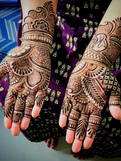 An angled view of the 'K' initial mehandi, showing the paisley and check patterns.