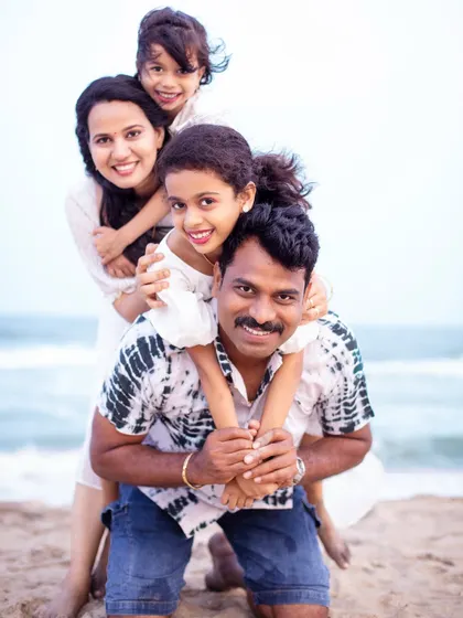 Another angle of this joyful family pose, capturing genuine smiles and laughter. It shows how we can create a variety of beautiful, connected portraits from a single fun idea.