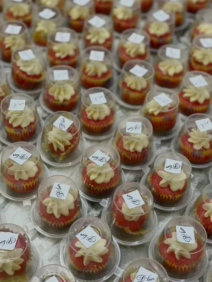 Hundreds of our mini red velvet cupcakes with cream cheese frosting, individually packaged and ready to be served as wedding favors. We ensure every detail is perfect for your big day.