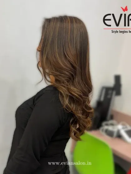 A side view of a soft, elegant balayage. The gentle waves and seamless color melt create a look that is both modern and timeless.