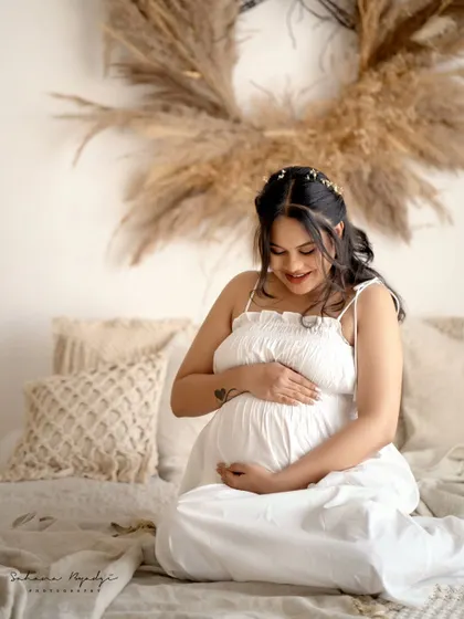 Another lovely shot from the same series, capturing a quiet moment of connection between mother and child in a relaxed, boho-inspired setting.