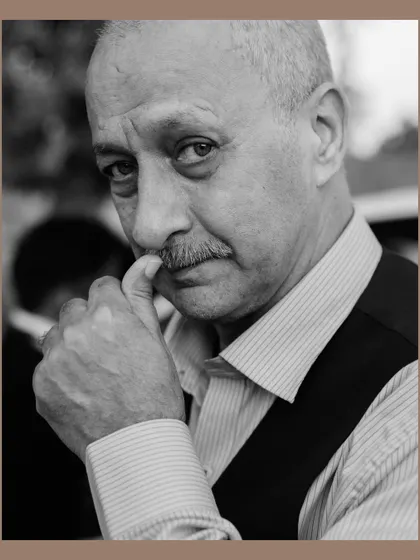 A striking black and white portrait of a male wedding guest. The close-up shot and his thoughtful expression create a compelling character study, capturing the personalities present at the event.