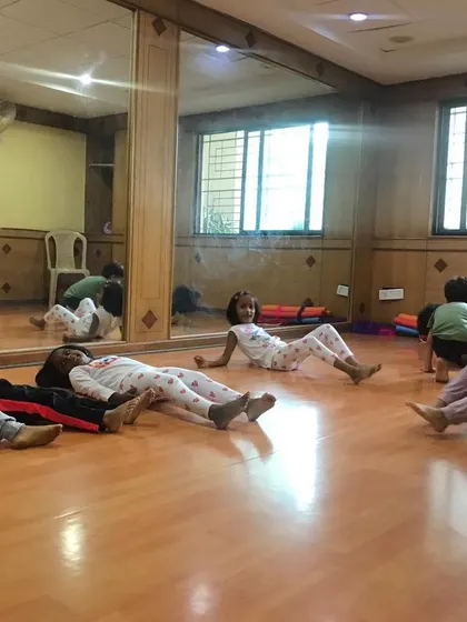 A look at our outdoor program, where we bring "Serious Fun" right to your apartment's doorstep. These images show kids enjoying gymnastics and yoga on mats in both indoor and outdoor community spaces.